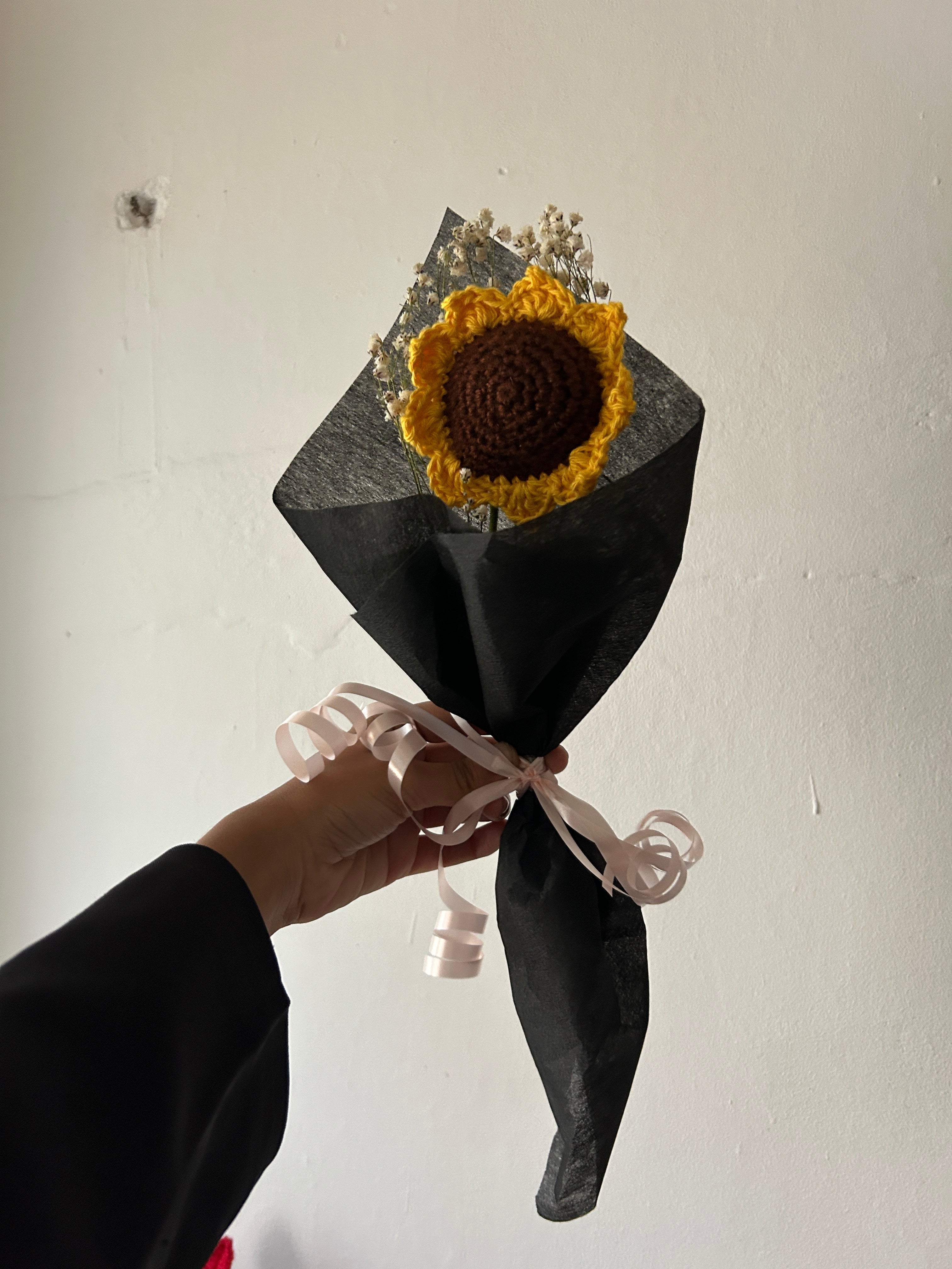 Single sunflower with wild flowers wrapped around in black theme